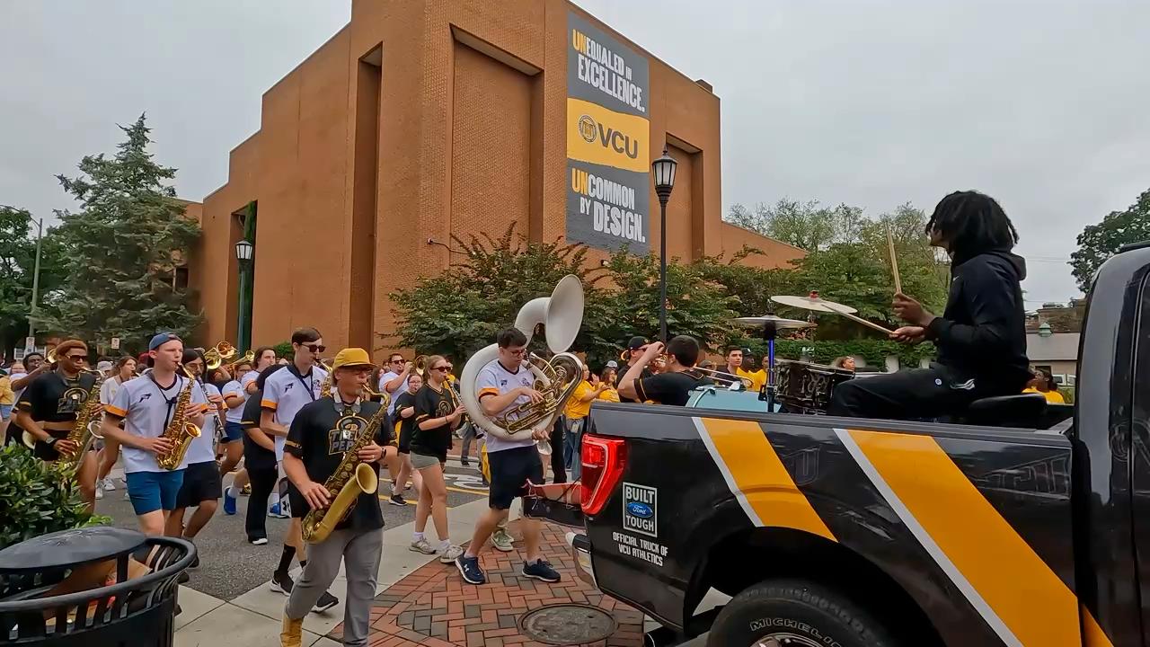 A looping video showing students and the VCU Peppas band parading through the streets and mascot Rodney the Ram interacting with students, as well as scenes of students on campus on the first day of school.