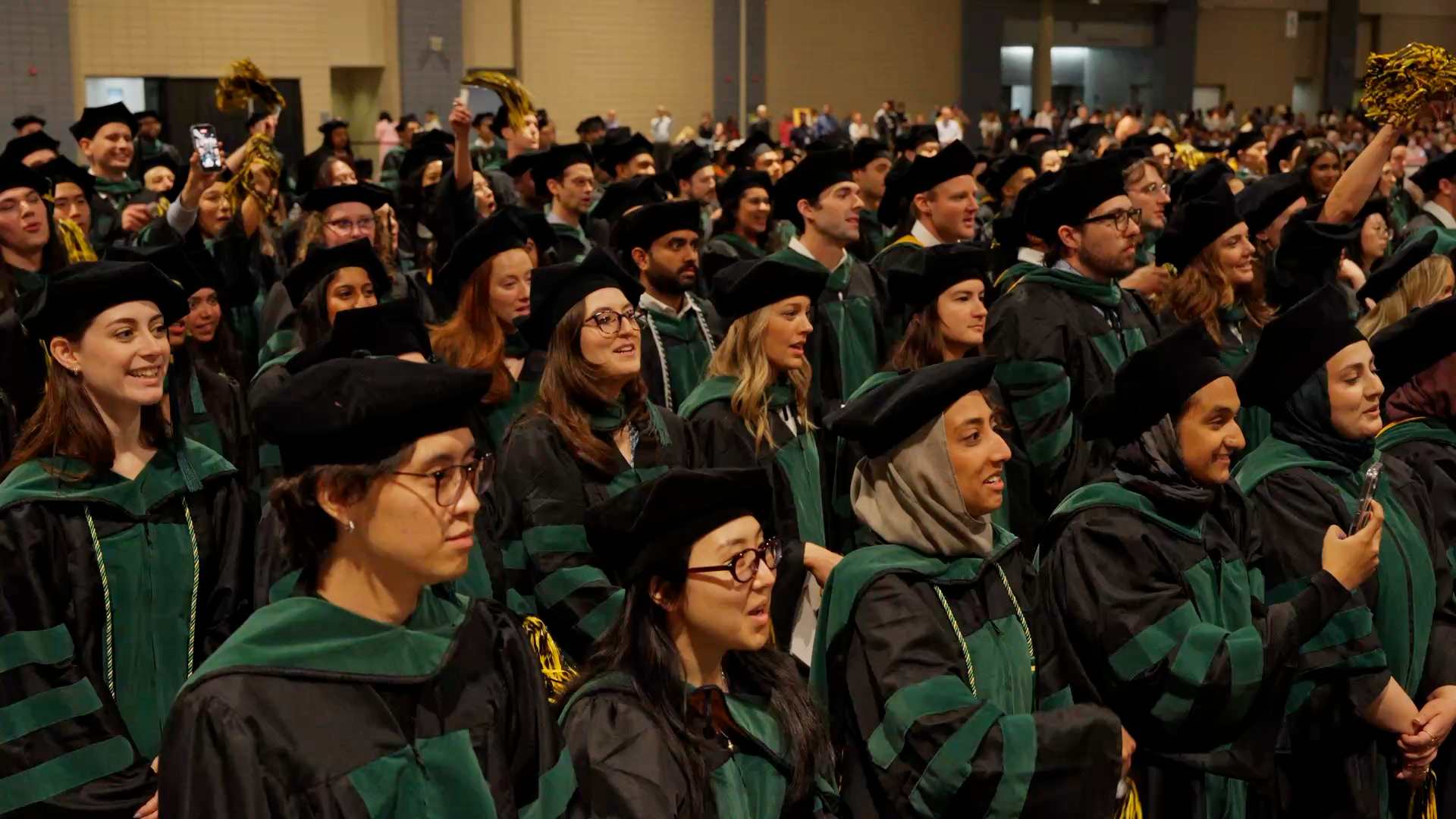 A crowd of graduates in caps and gowns at VCU's main commencement ceremony.
