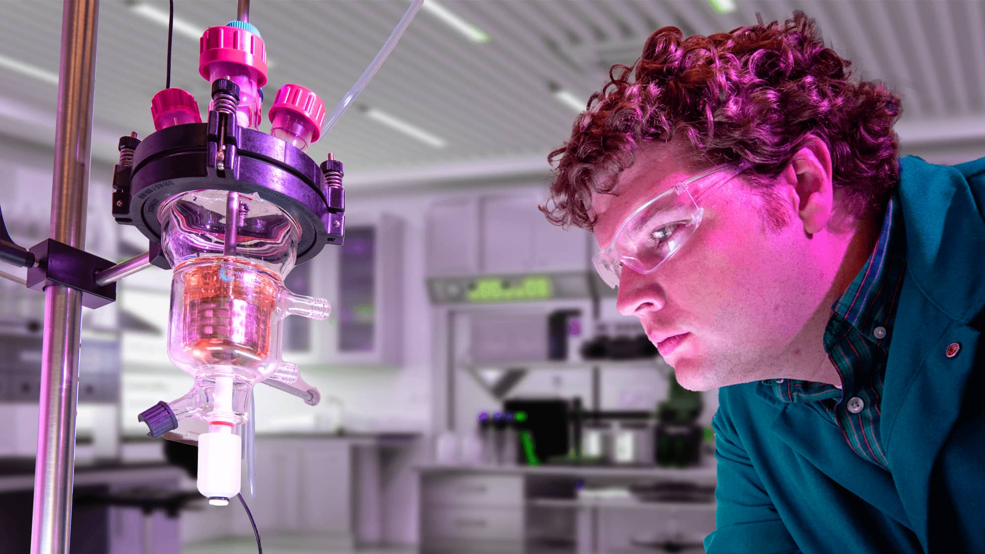 Male student wearing protective goggles in a VCU science laboratory