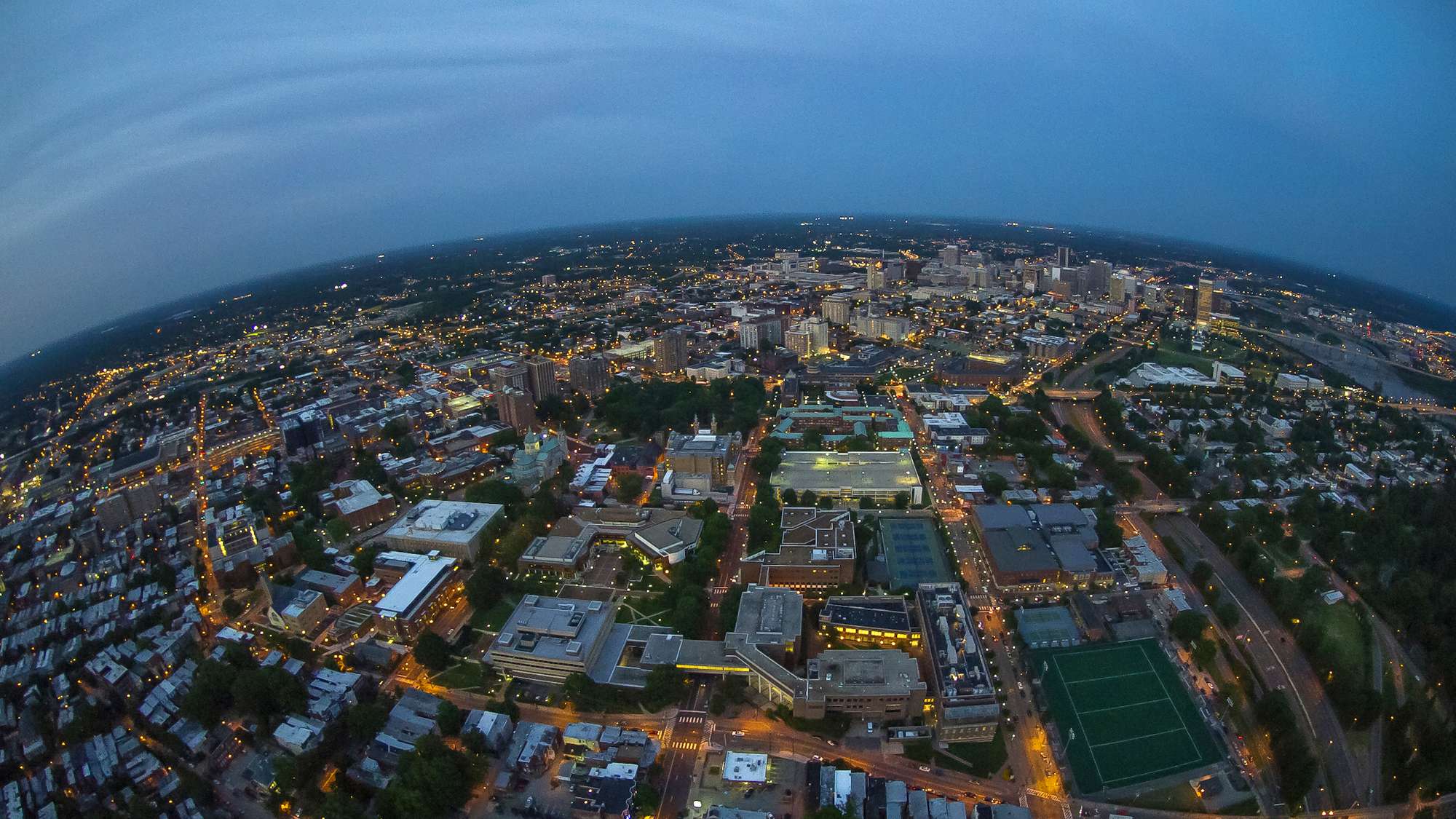 Photo showing an aerial view of VCU and the Richmond, Virginia city skyline at night