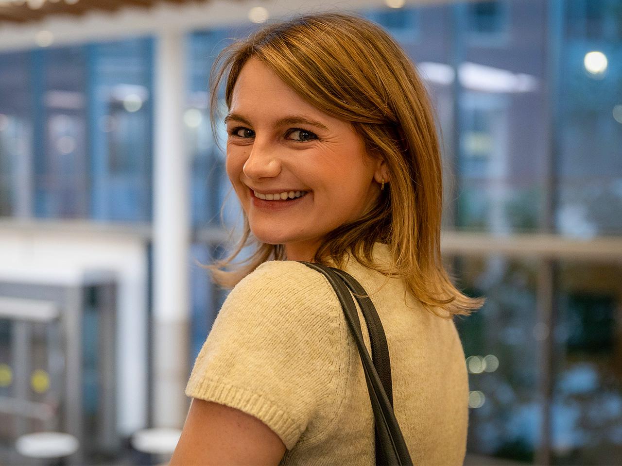 Kaity Myers turning and looking back while smiling at the camera