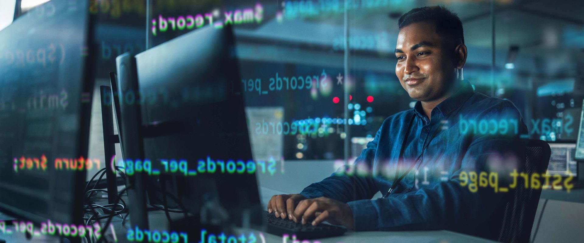 Professional looking contently at their computer monitor. An translucent overlay of code is visible above and below their head.