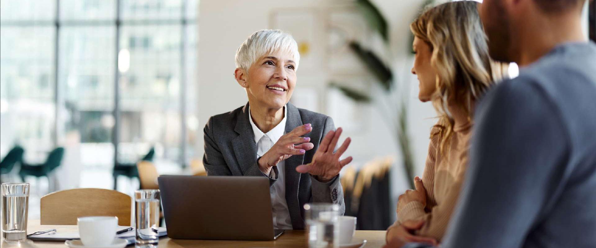 Accountant in front of laptop giving advice to a couple