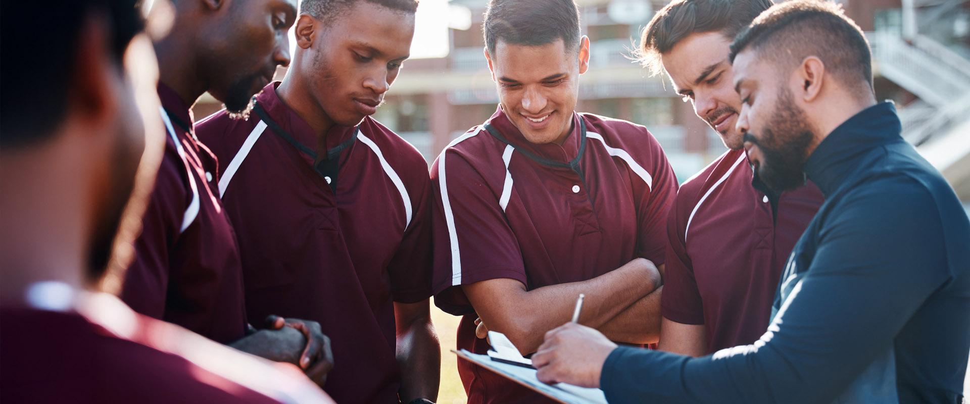 Young professional holding a tablet in the stands of a sports arena