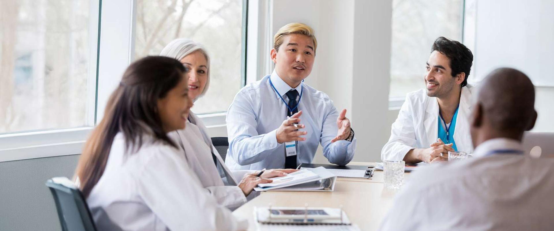 A group of heath care professionals discussing and coordinating care