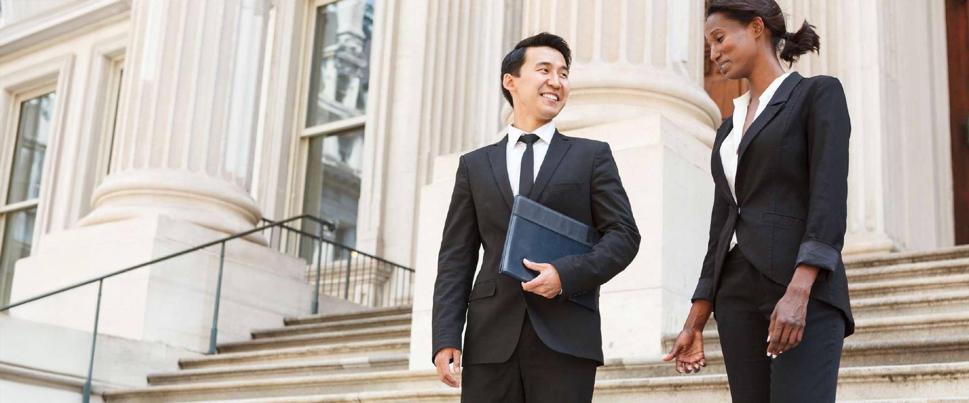 A group of two public policy experts in business suits walking on the steps of the Capitol.
