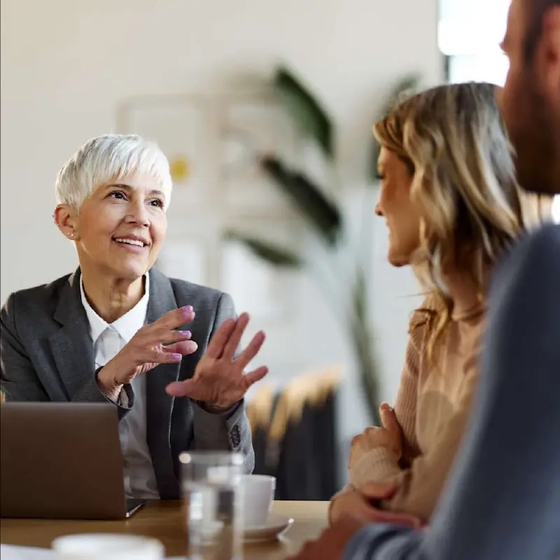 Accountant in front of laptop giving advice to a couple