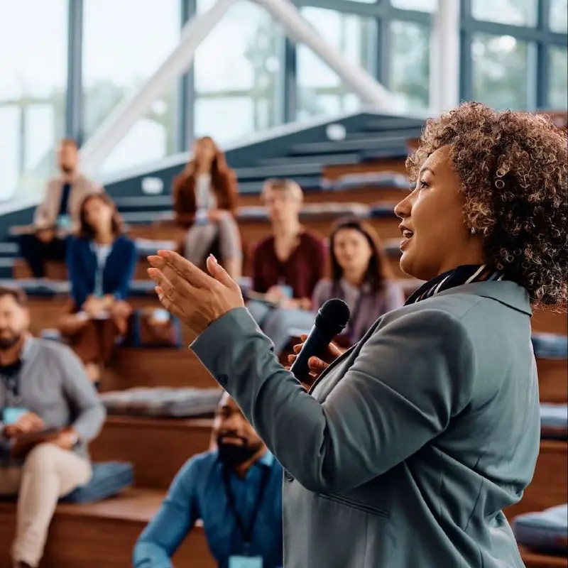 Community-based leader gives empowering speech to a group