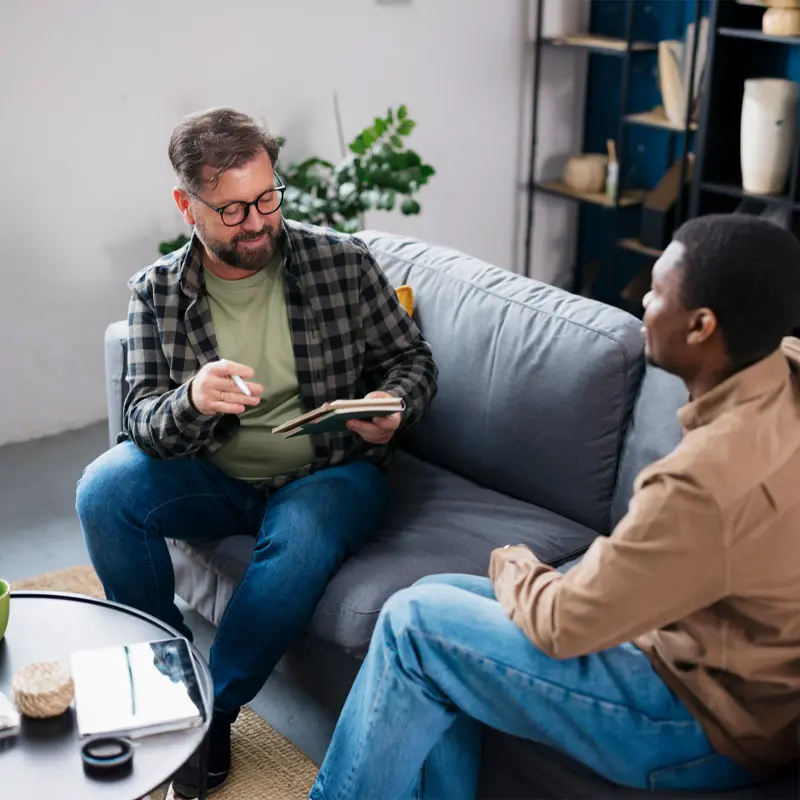 A client looking motivated while meeting with a health behavior coach