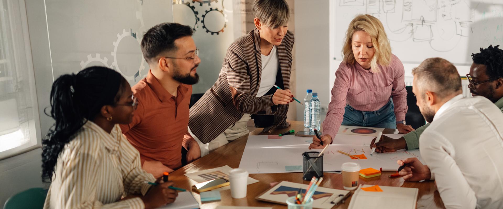 A group of marketing professionals collaborate in a conference room. 